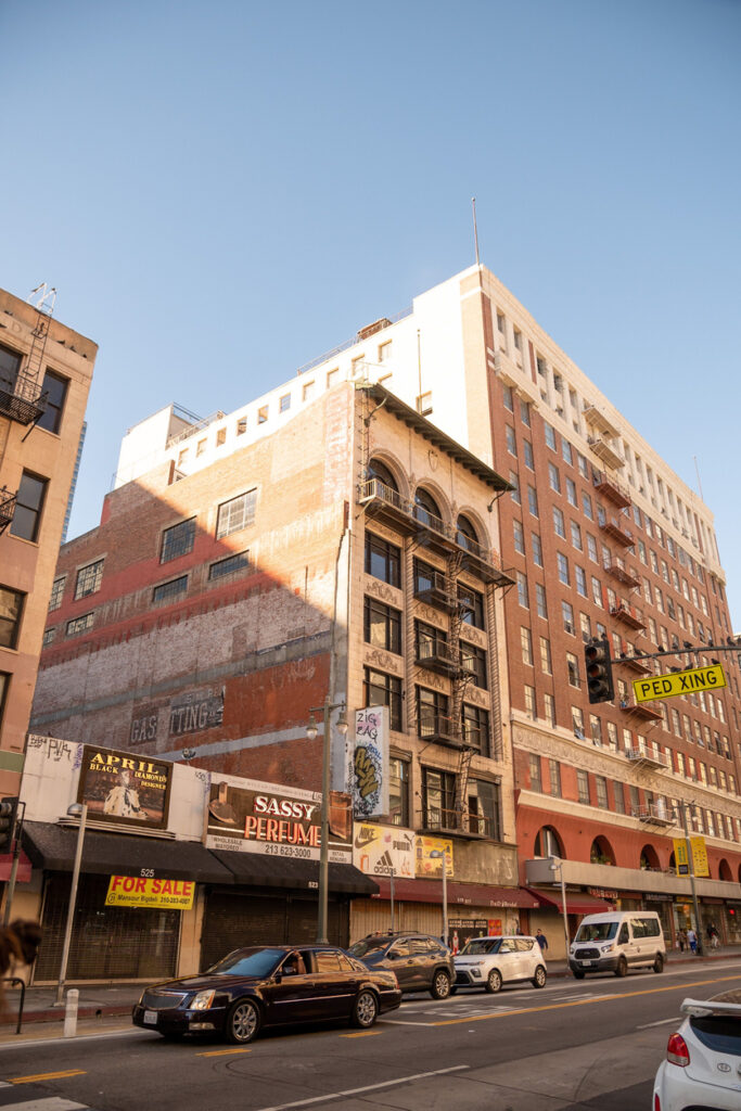 Abandoned commercial building with boarded-up windows, symbolizing the rising delinquency rates in the commercial real estate market, including multifamily and lodging sectors.